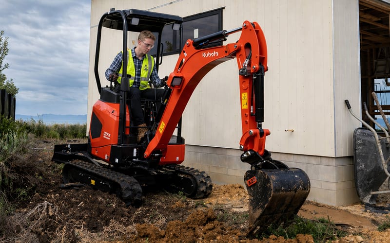 Sub-compact tractor navigating a residential backyard